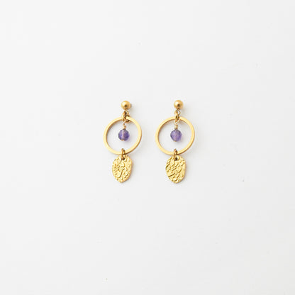 A pair of gold dangle earrings with a small purple bead and textured gold leaf charms, displayed on a clean white background.