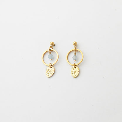 A pair of gold dangle earrings with circular hoops, small light blue beads, and textured leaf charms, displayed on a clean white background.