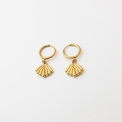 A pair of gold hoop earrings with dangling scallop-shaped charms, displayed on a clean white background.