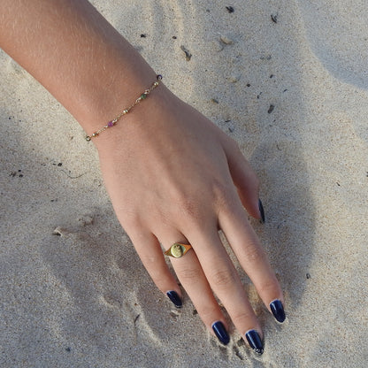 October birthstone bracelet with interchanging gold pebbles and gemstones