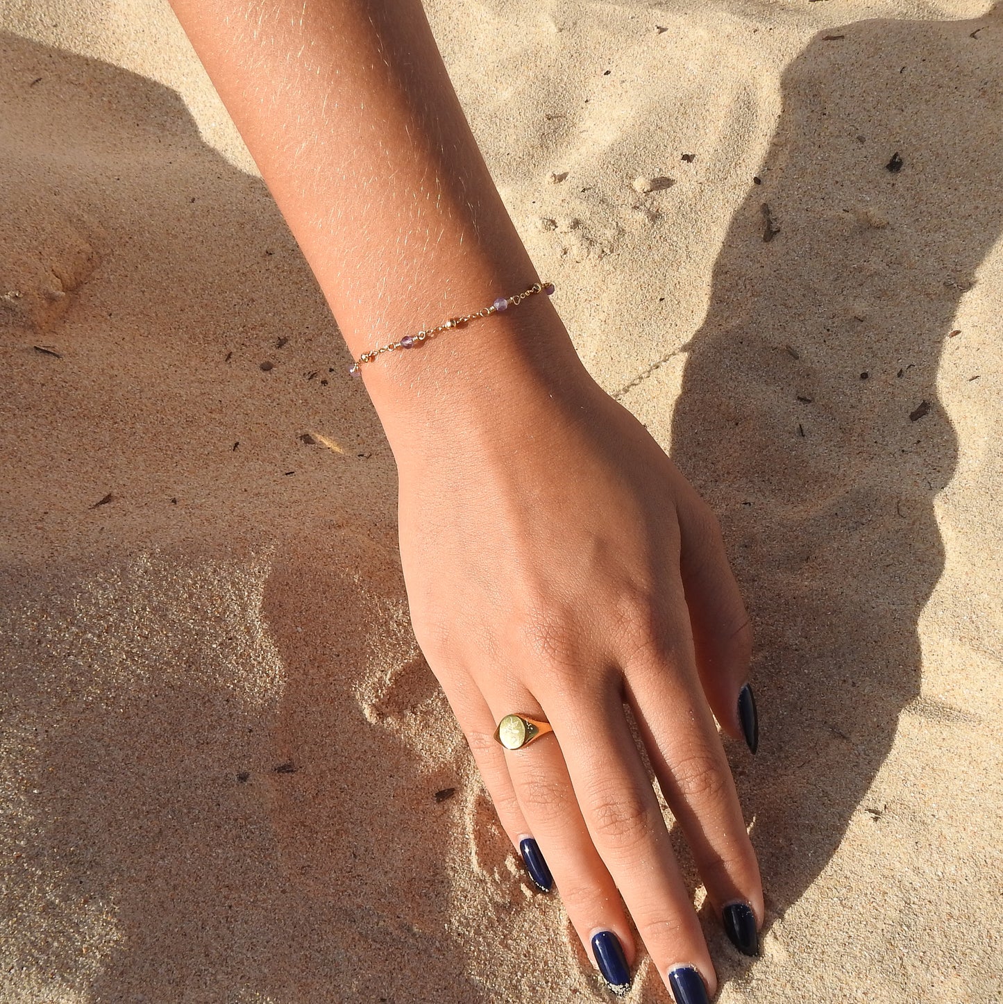February birthstone bracelet with interchanging gold pebbles and gemstones