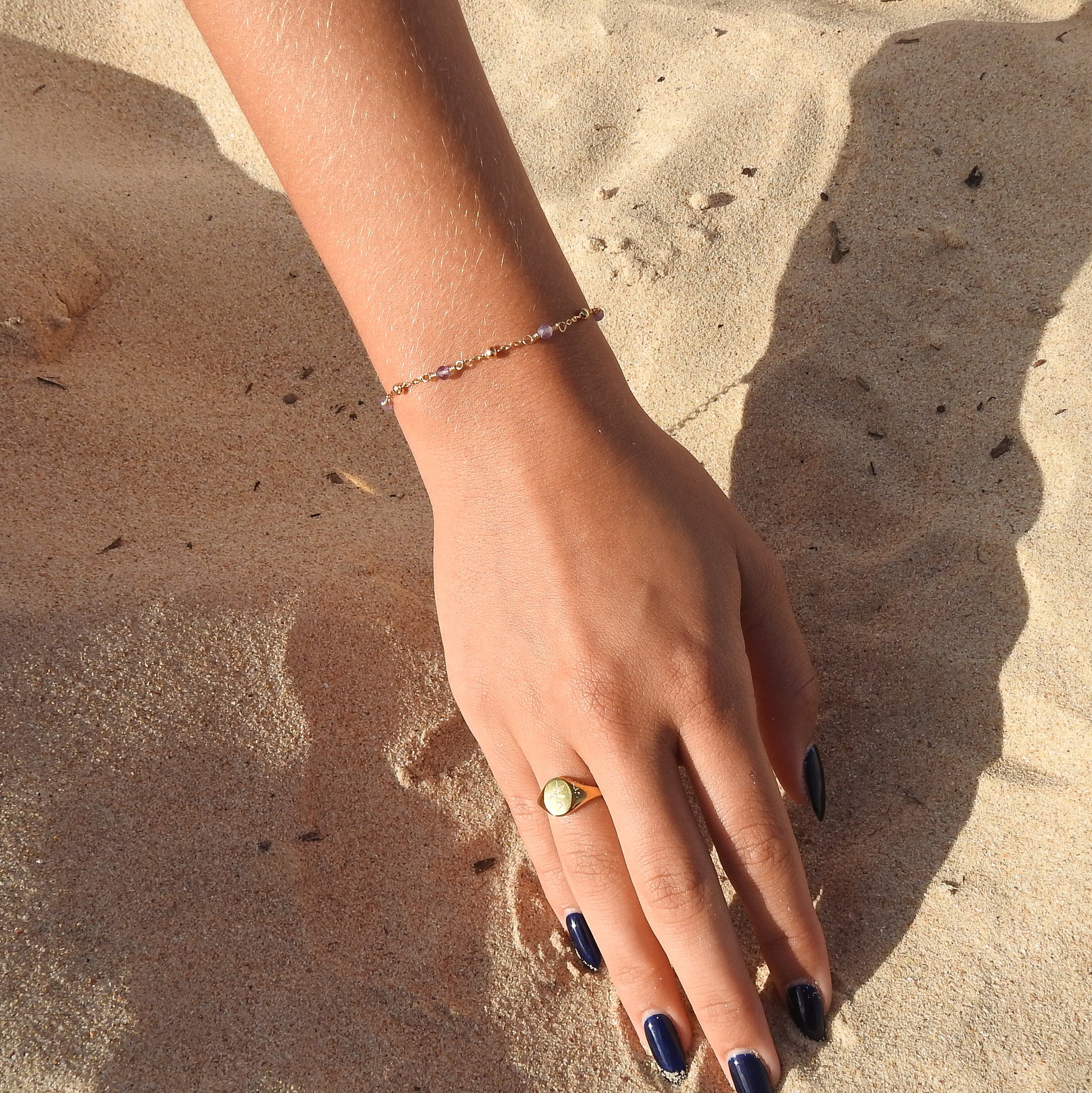 February birthstone bracelet with interchanging gold pebbles and gemstones