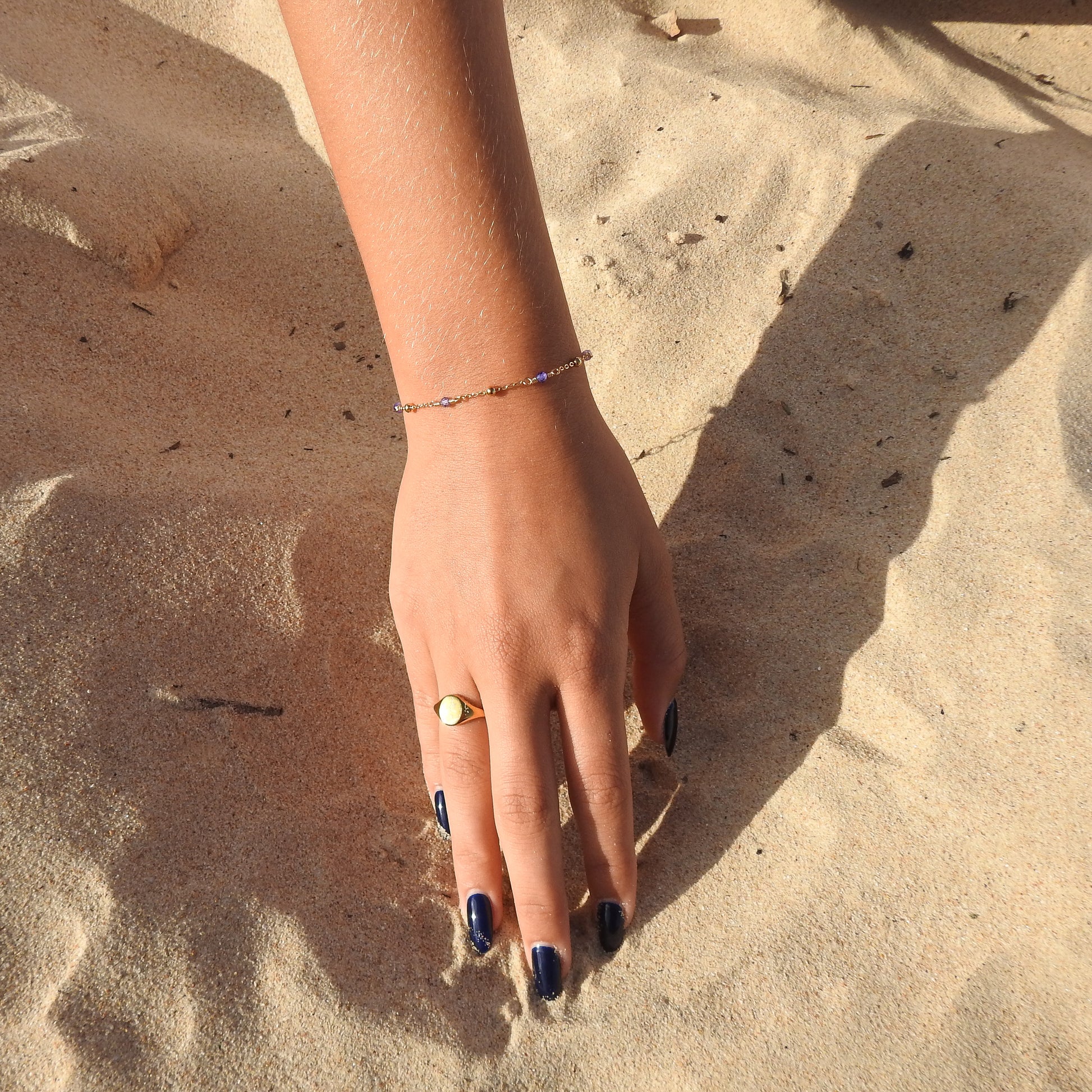 December birthstone bracelet with interchanging gold pebbles and blue zircoin gemstones