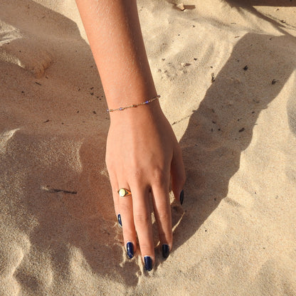 December birthstone bracelet with interchanging gold pebbles and blue zircoin gemstones