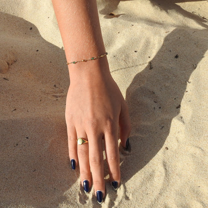 May birthstone bracelet with interchanging gold pebbles and gemstones