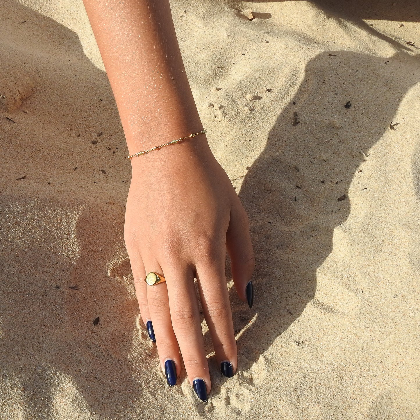 August birthstone bracelet with interchanging gold pebbles and peridot gemstones