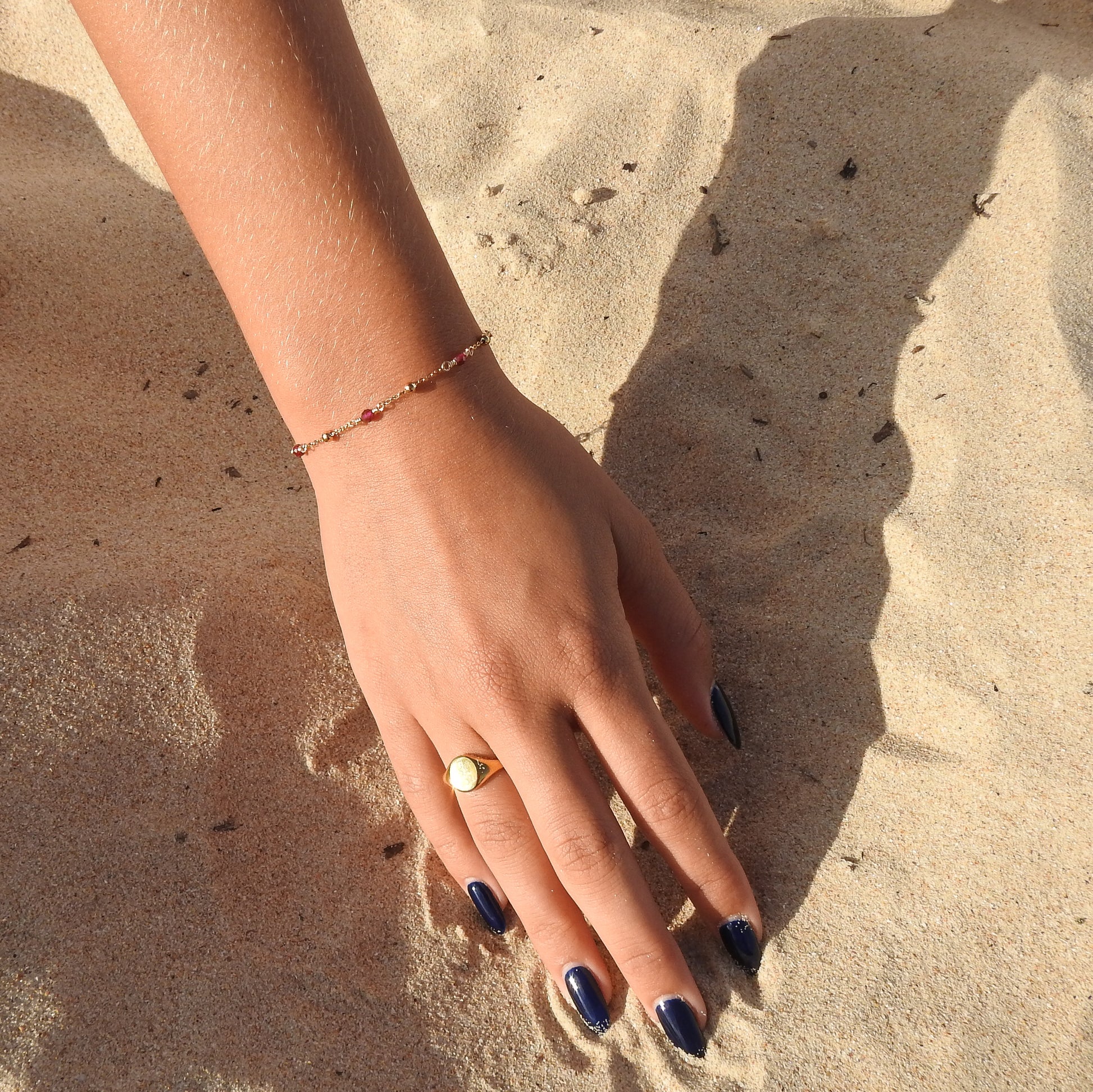 July birthstone bracelet with interchanging gold pebbles and gemstones