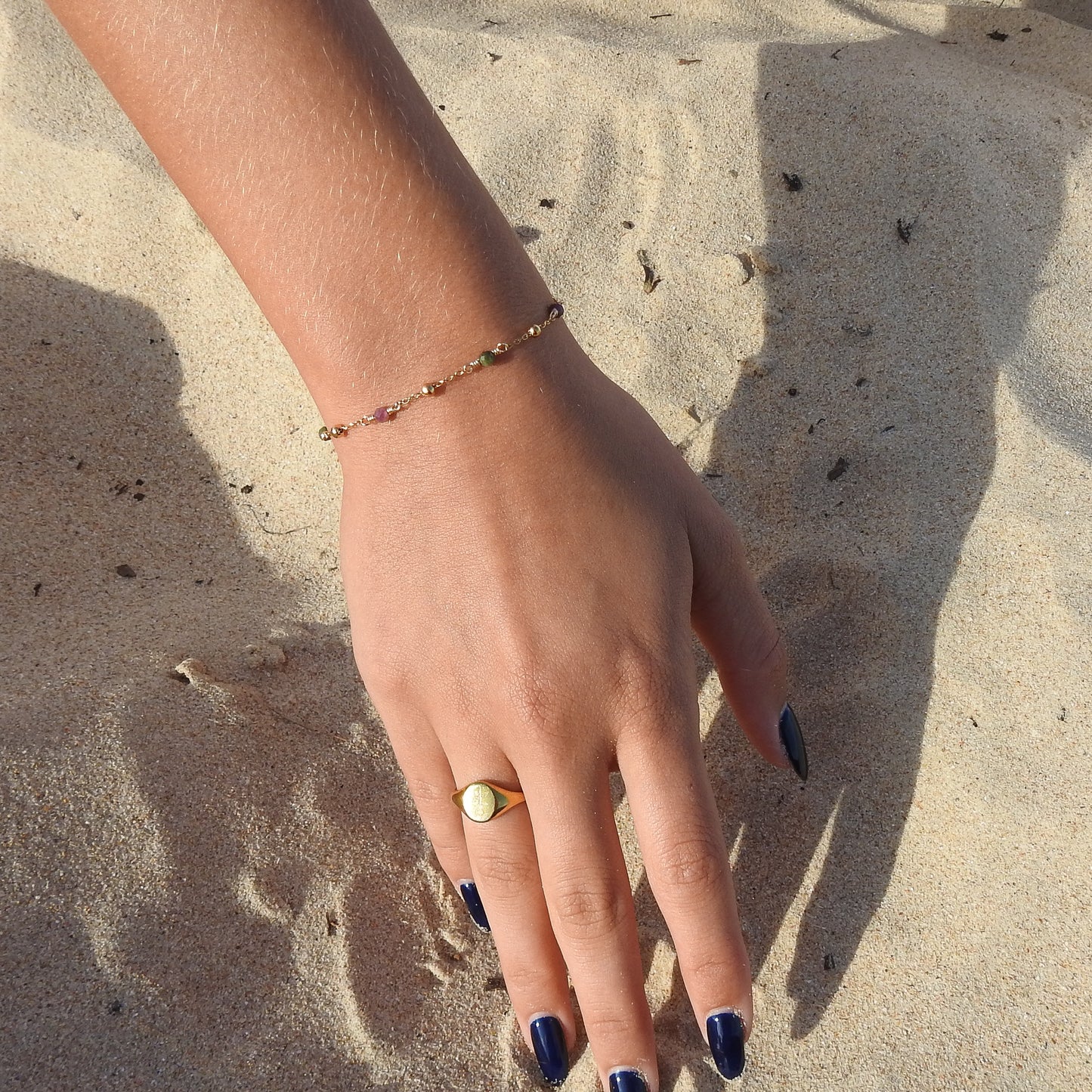 October birthstone bracelet with interchanging gold pebbles and gemstones