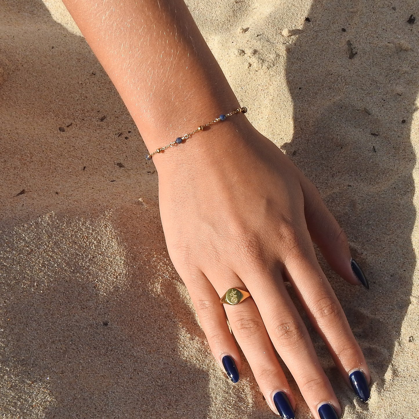 September birthstone bracelet with interchanging gold pebbles and sapphires
