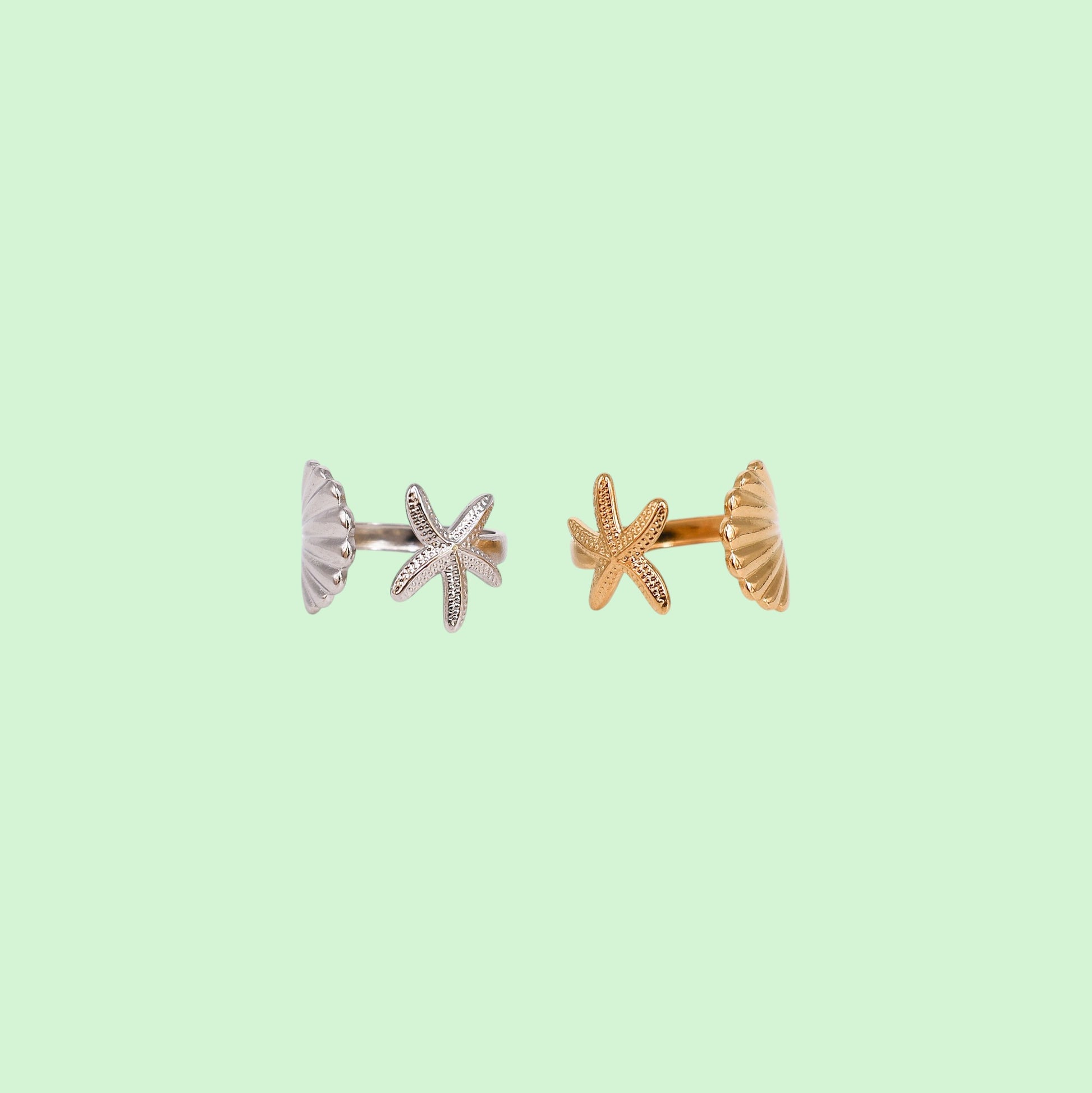 Shell & Starfish adjustable rings in gold and silver on a light green background